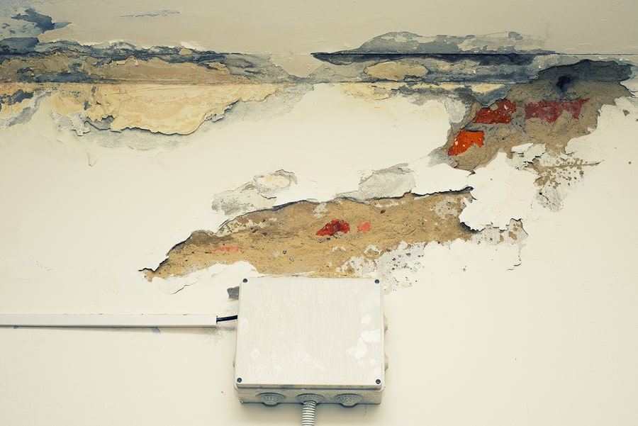 water damaged wall above wires