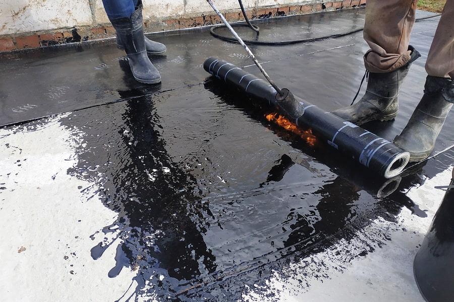 waterproofing contractor brushing membrane