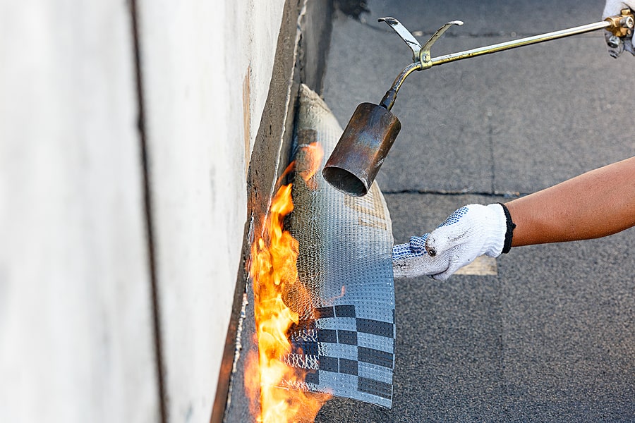 waterproofing contractors applying flame to material